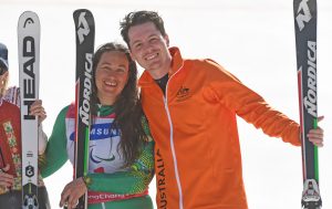 An image of Melissa Perrine and Christian Geiger smiling while holding ski equipment