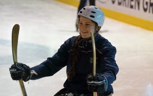 Image of a female athlete playing para-ice hockey
