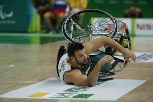 An image of Bill Latham in action during a wheelchair basketball game