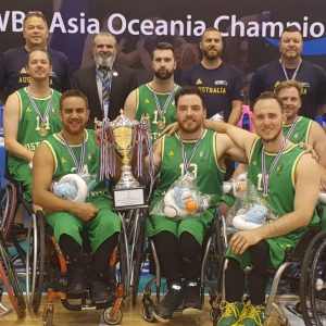 An image of a para-athlete team with the winners cup and medals