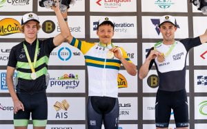 Image of three male athletes posing with their medals and smiling.