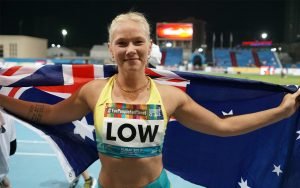 female paralympian smiling with Australian flag