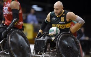 Image of male wheelchair rugby player Chris Bond with the ball