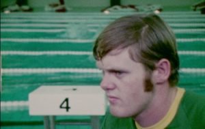 Profile image of male Paralympic swimmer Eric Boulter sitting beside a swimming pool