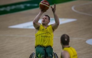 Australian male wheelchair basketball player taking a shot at goal