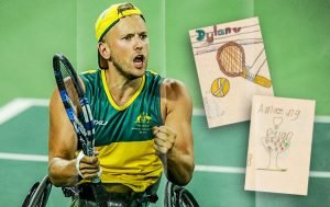 Male wheelchair tennis player, dressed in green and gold, holding a racket in his right hand and pumping his left fist.