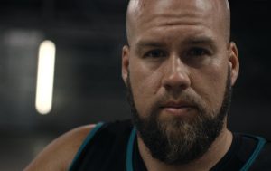 Male Wheelchair Rugby Paralympian Ryley Batt looking straight ahead with a serious expression on his face.
