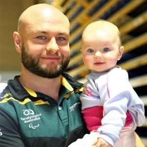 Image of ustralian Steelers Wheelchair Rugby player Chris Bond holding his daughter Victoria.