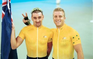 Paul Clohessy and Darren Harry on podium smiling with Australian Flag