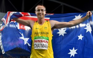 Australian Paralympian Aaron Chatman holding an Australian flag around his shoulders