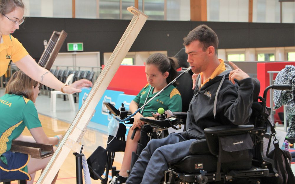 Image of two wheelchair Para-athletes playing boccia