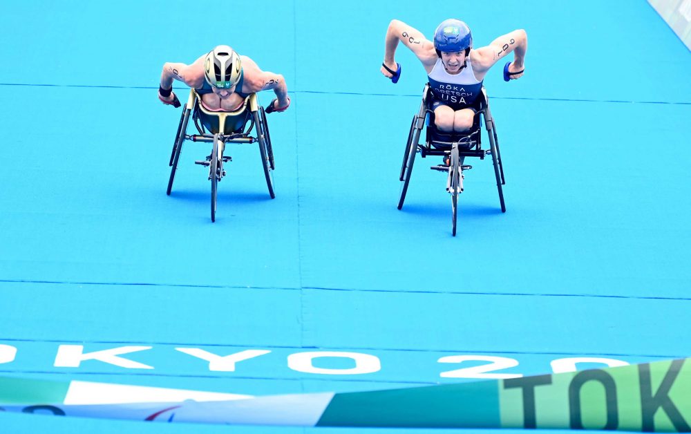 Two athletes power towards the finish line in the Para-triathlon