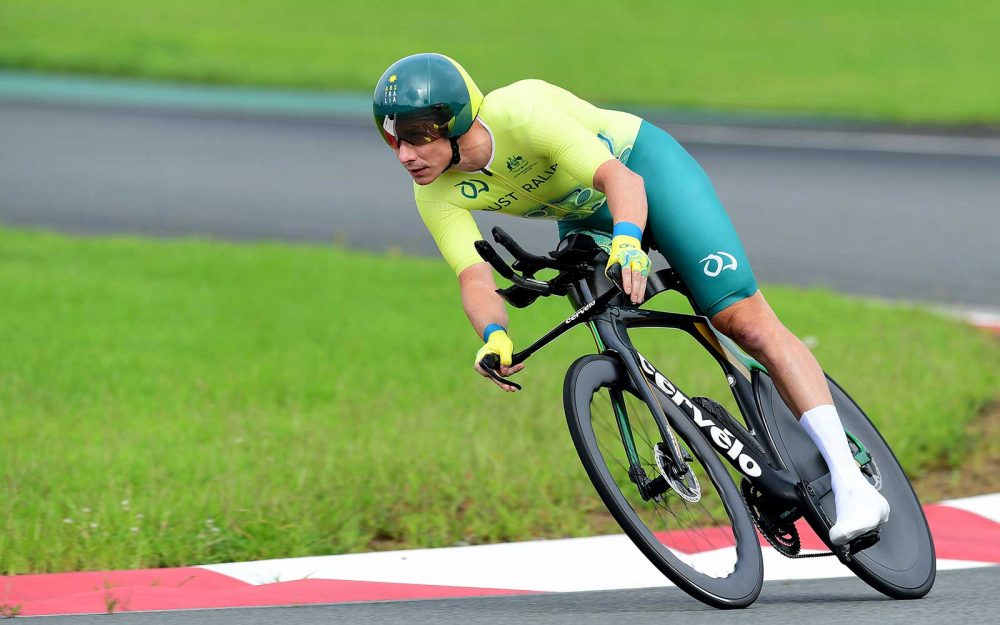 A male cyclist representing Australia riding his bike on a road