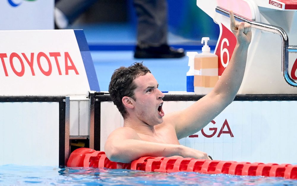 Male Australian Para-swimmer Ben Hance celebrating in the pool after winning a bronze medal.