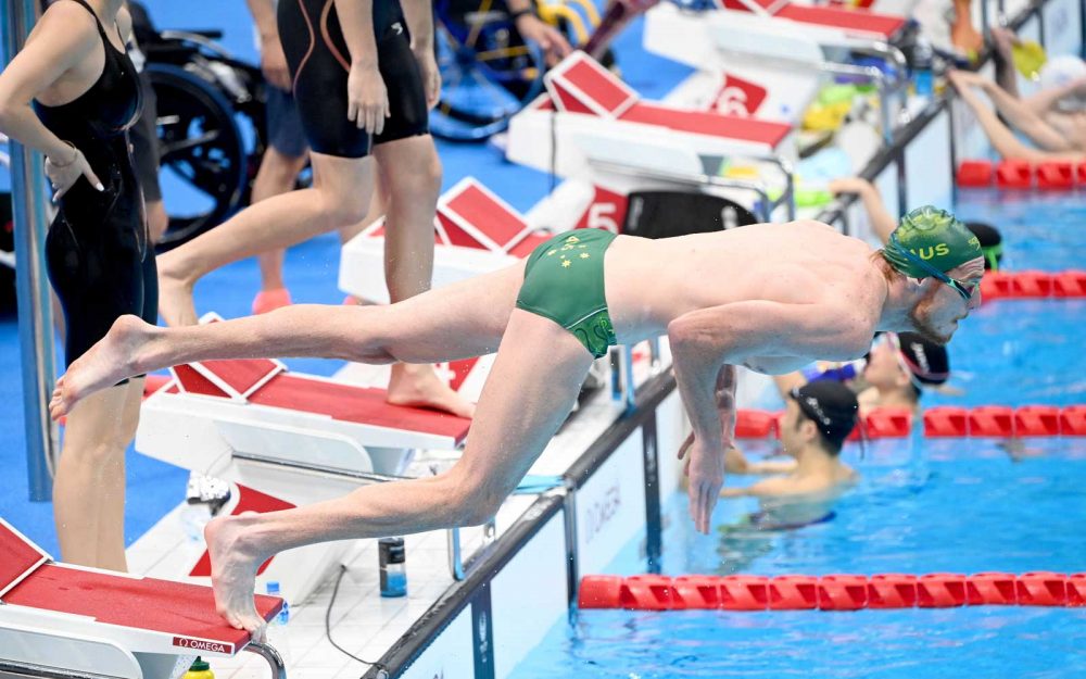 Swimmer diving from blocks into the pool