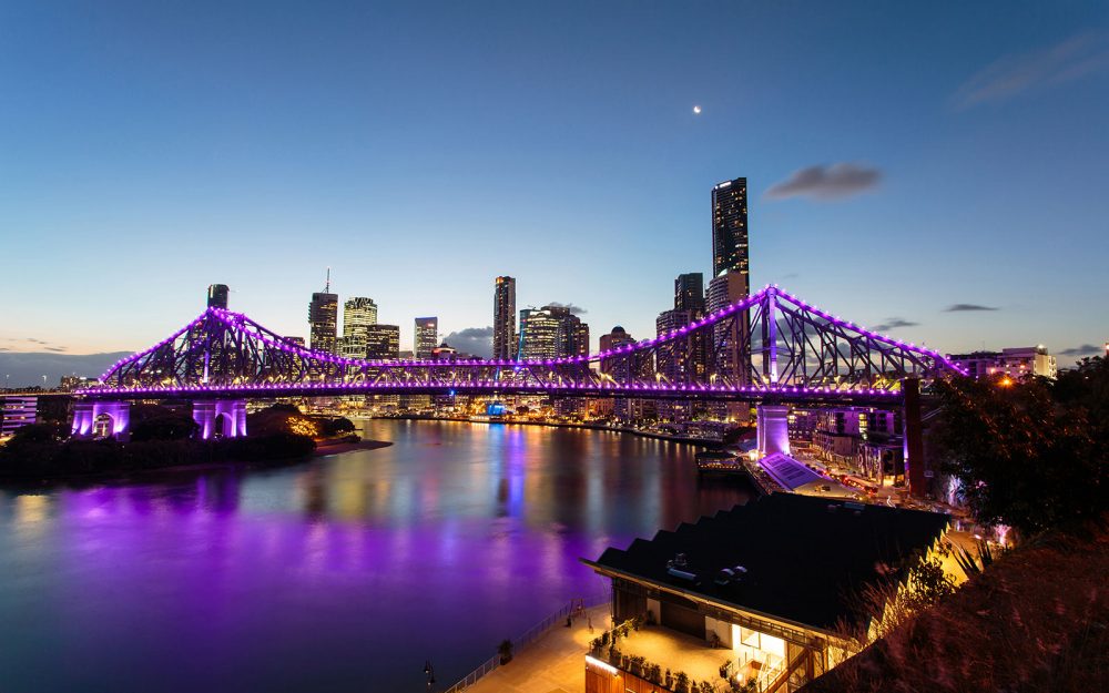 Story Bride In Brisbane at night lit up with purple lights