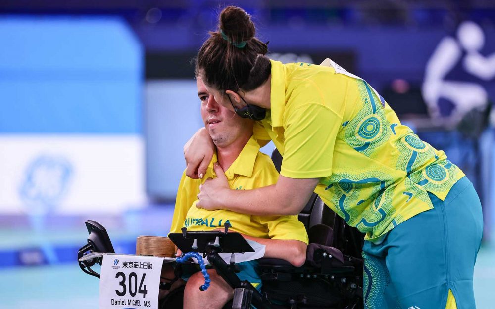 Australian Paralympian Dan Michel is hugged by Ashlee McClure