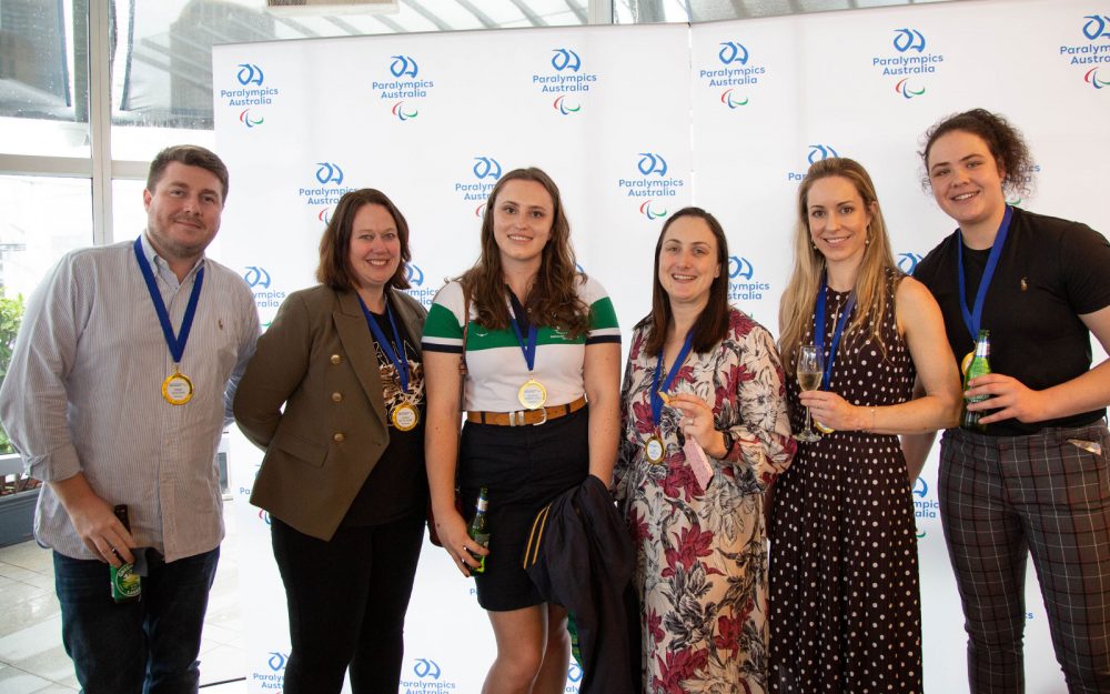 Australian Paralympians and Paralympics Australia staff and sponsors smiling for a photo