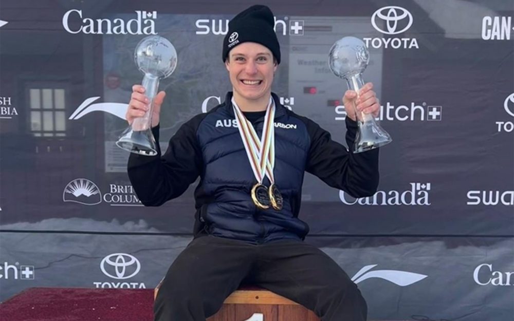 Australian Paralympian Ben Tudhope holding his 2 Para-snowboard Crystal Globe awards