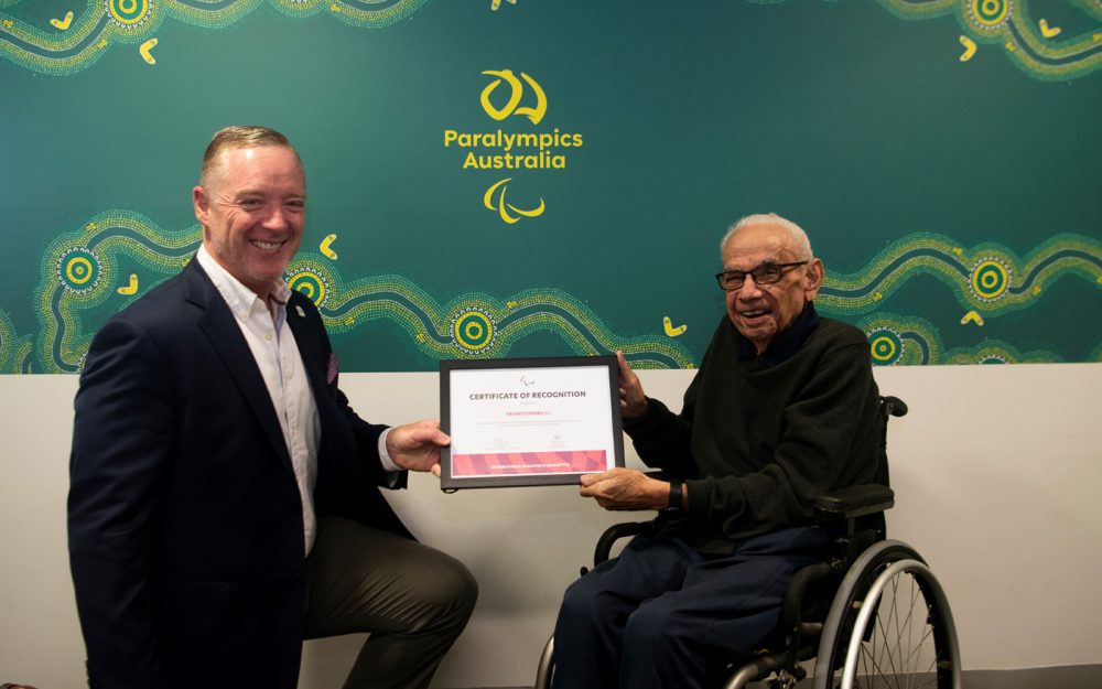 Paralympics Australia President Jock O'Callaghan and Australian Paralympian Kevin Coombs holding an award