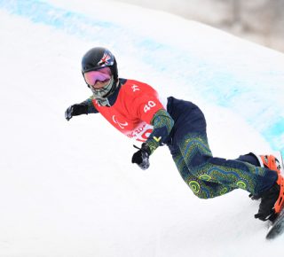 Australian Paralympian Ben Tudhope snowboarding the Banked Slalom at Beijing 2022