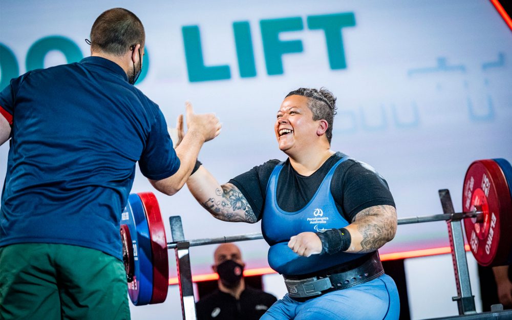Australian Para-powerlifting athlete Hani Watson high fiving her coach