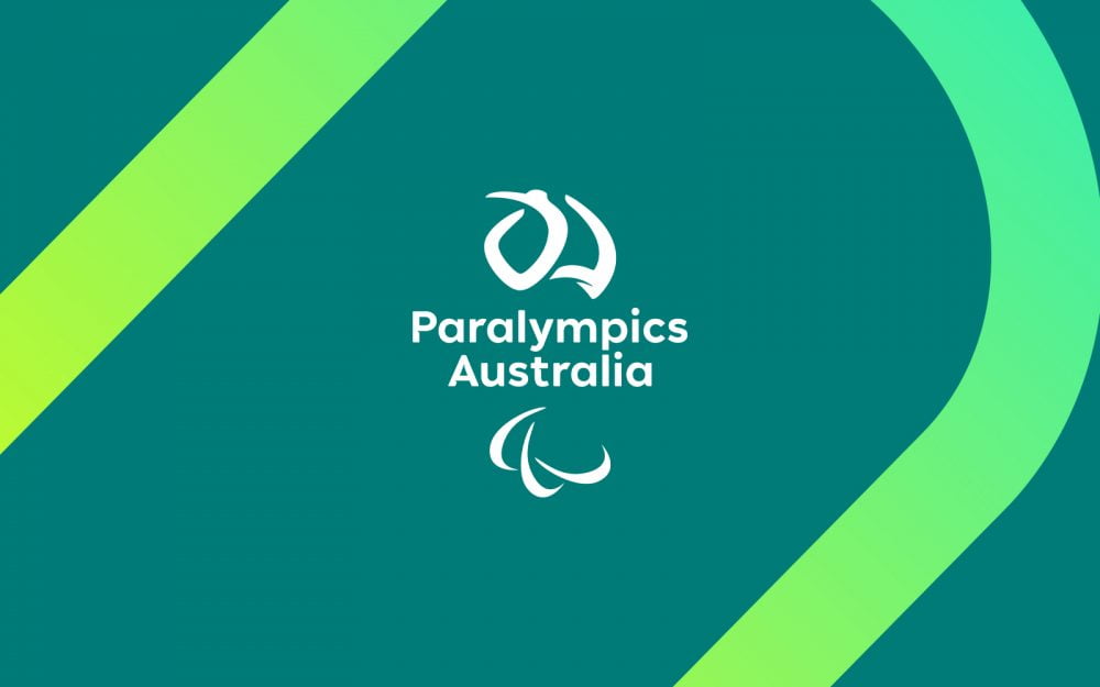 A white PA logo on a green background