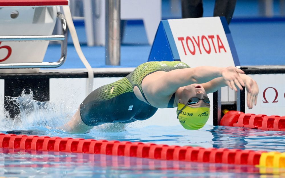 Australian Paralympian Maddie McTernan diving backwards into the water.