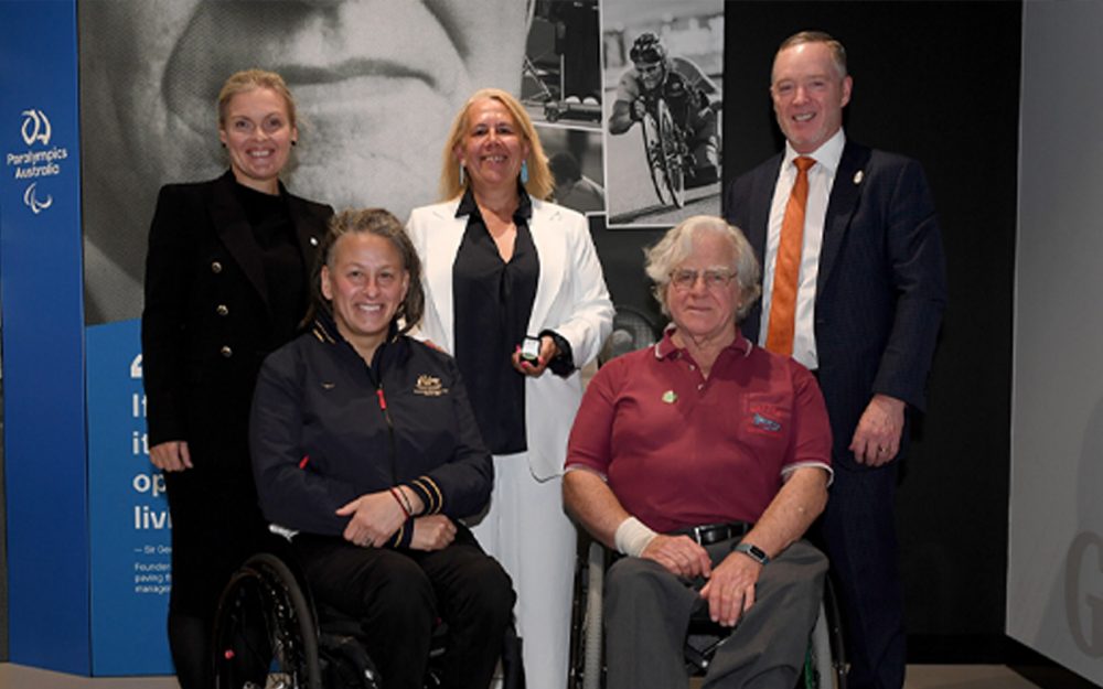 The CEO and President of Paralympics Australia with Paralympians and family accepting pins.