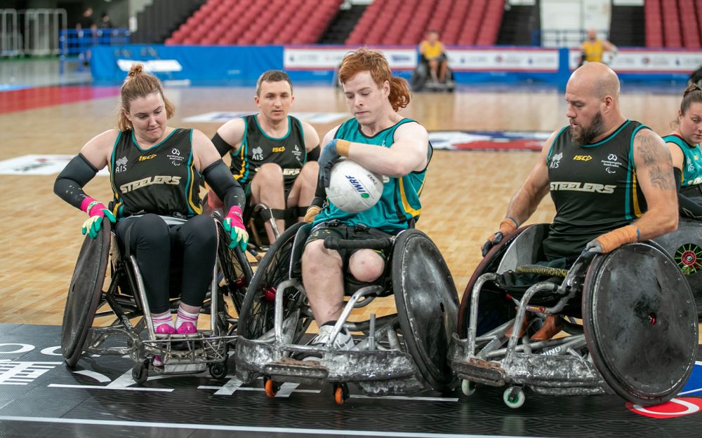 Brayden Foxley-Connolly training for Wheelchair rugby with Steelers teammates surrounding him.