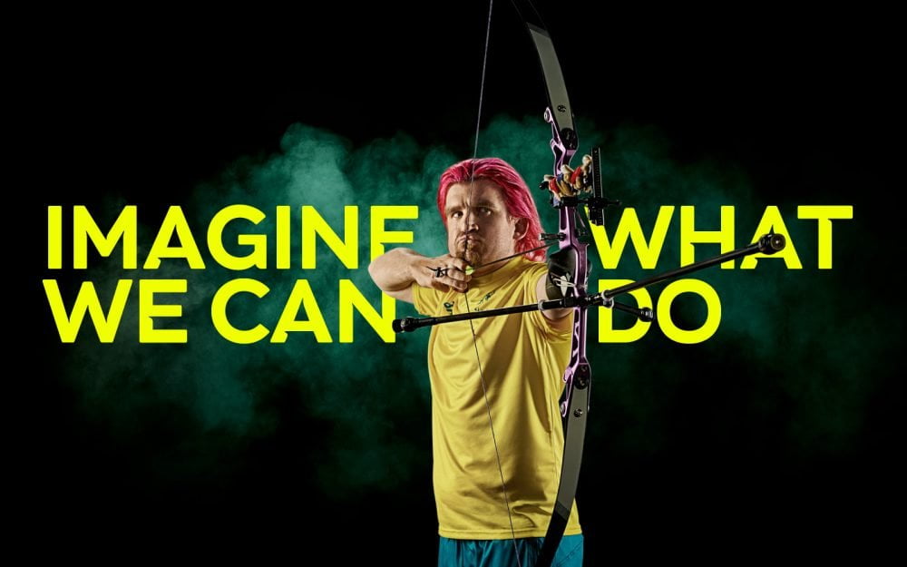 Australian Para-archer Taymon Kenton-Smith shooting his arrow. Text reads: Imagine What We Can Do.