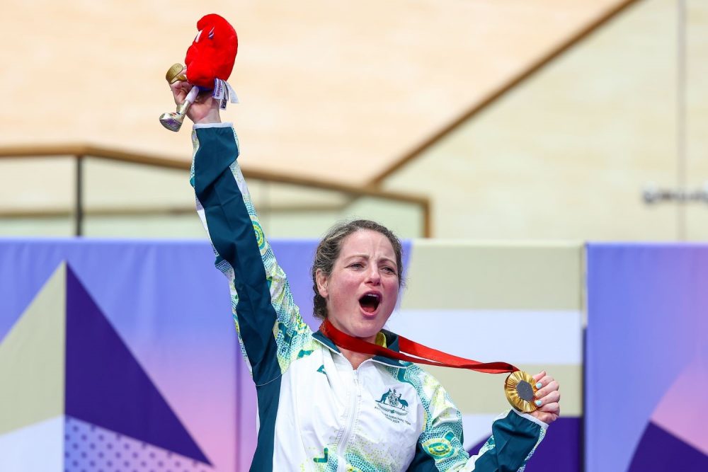 Para-cyclist Emily Petricola on the podium to accept her gold medal.