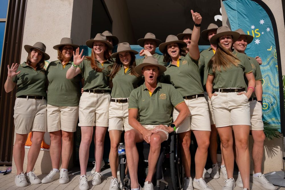 The rowing team pose in their ceremonial opening ceremony outfits.