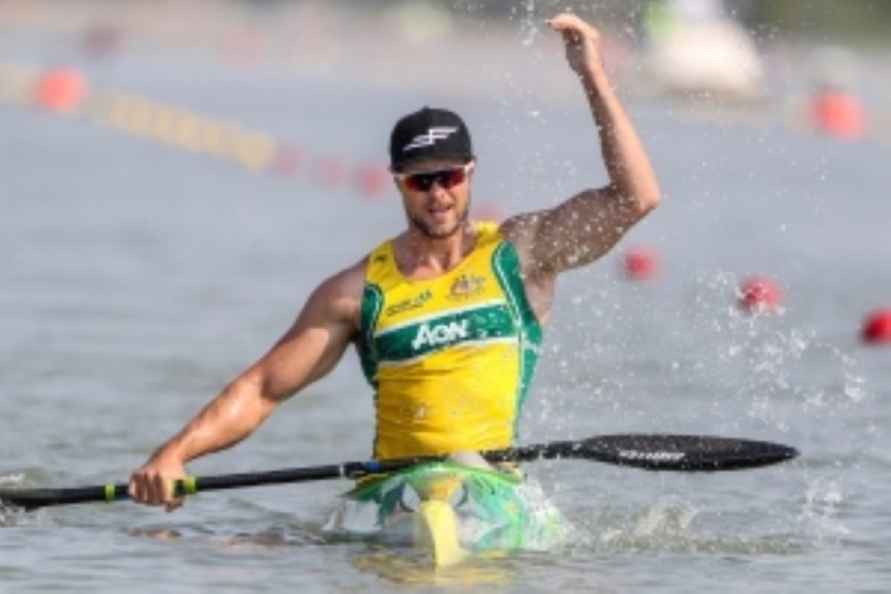 Curtis McGrath celebrates post race by splashing the water.