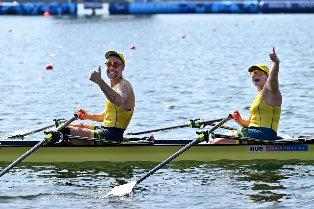Jed Altschwager and Nikki Ayers celebrate at the end of the gold medal-winning race