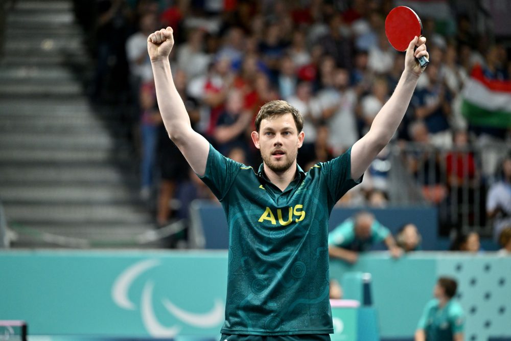Victorius Samuel von Einem raises his hands after winning bronze in the para-table tennis mens singles.