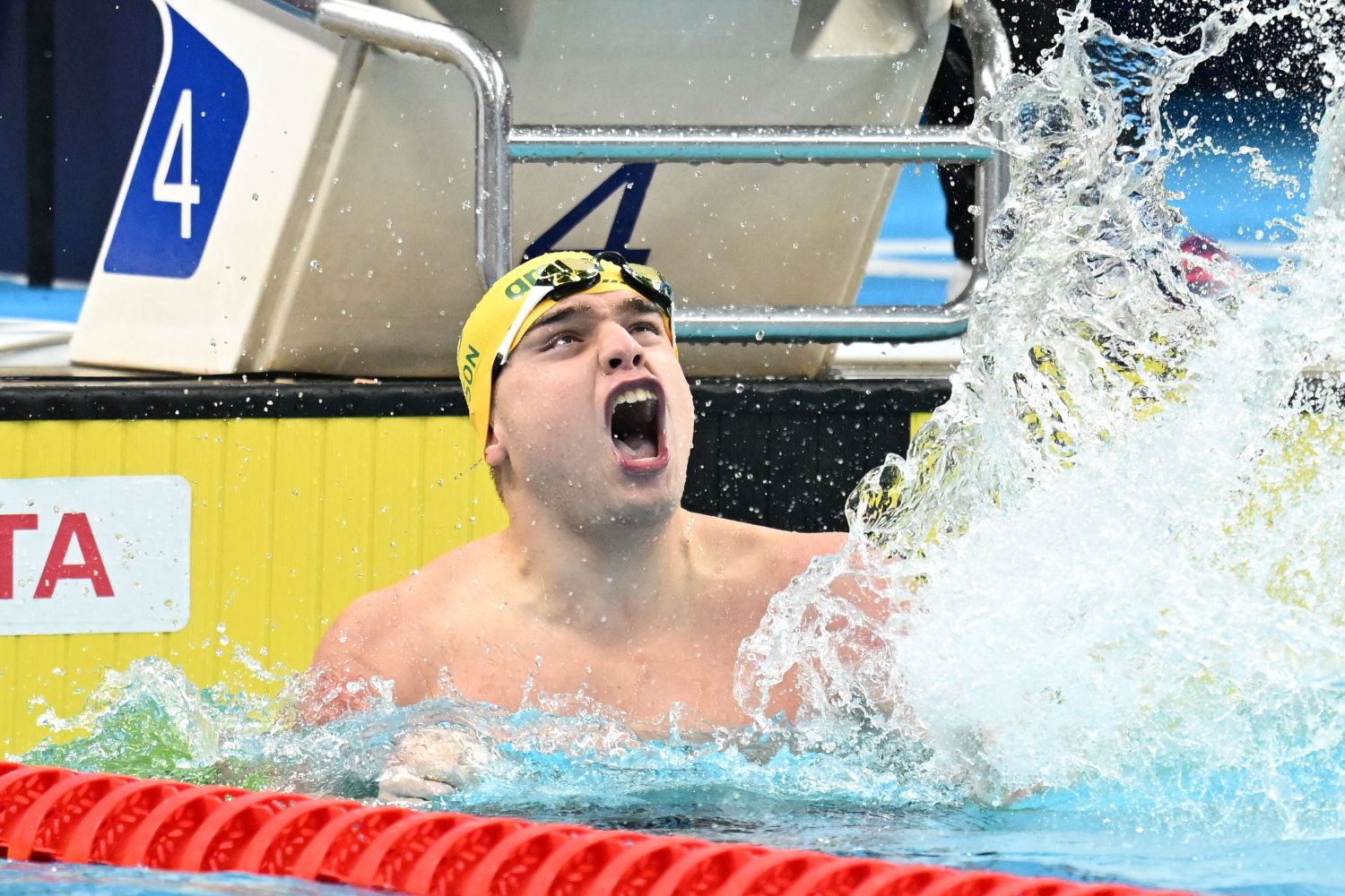 Para swimmer Callum Simpson celebrates with a splash.