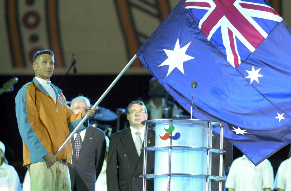 Brendan Burkett waving the Australian flag.