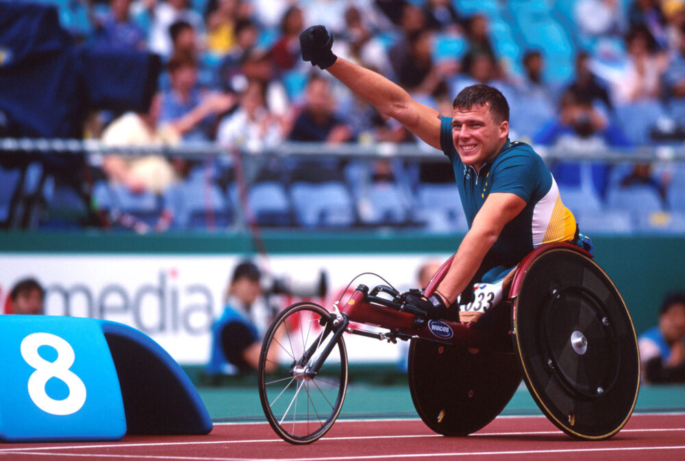 Kurt Fearnley waving at the Sydney 2000 Paralympic Games.
